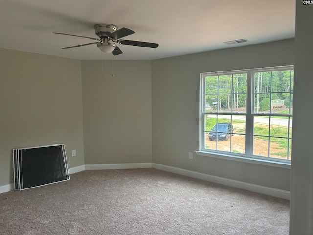 empty room with ceiling fan and carpet