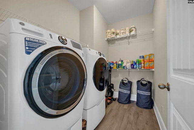 laundry room featuring washer and dryer and light wood-type flooring