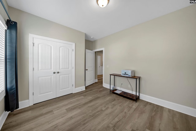 bedroom with wood-type flooring and a closet