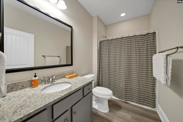 bathroom featuring hardwood / wood-style floors, vanity, and toilet