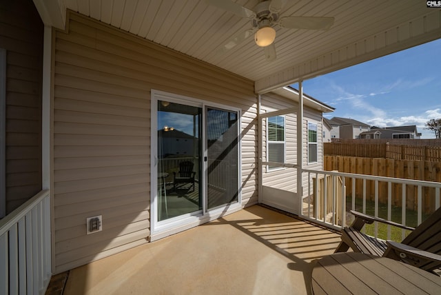 unfurnished sunroom featuring ceiling fan and a healthy amount of sunlight