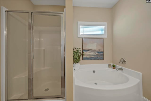 bathroom featuring independent shower and bath