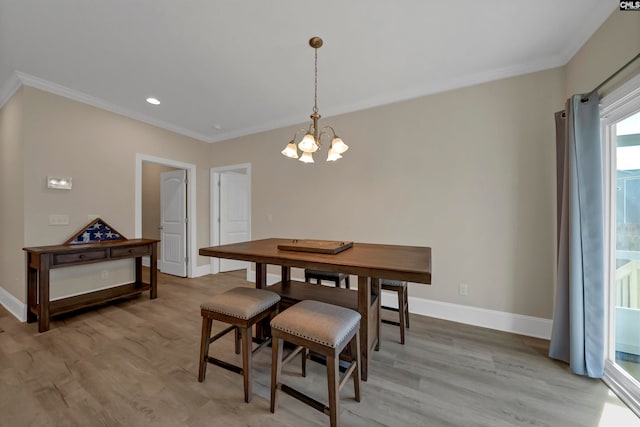 dining room featuring a notable chandelier, crown molding, and wood-type flooring