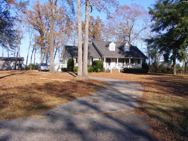 cape cod-style house with a porch