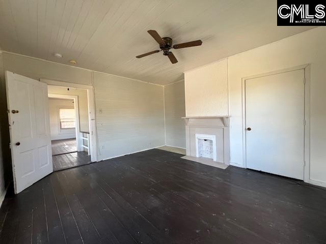 unfurnished living room with hardwood / wood-style flooring and ceiling fan