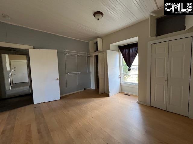 unfurnished bedroom featuring light wood-type flooring