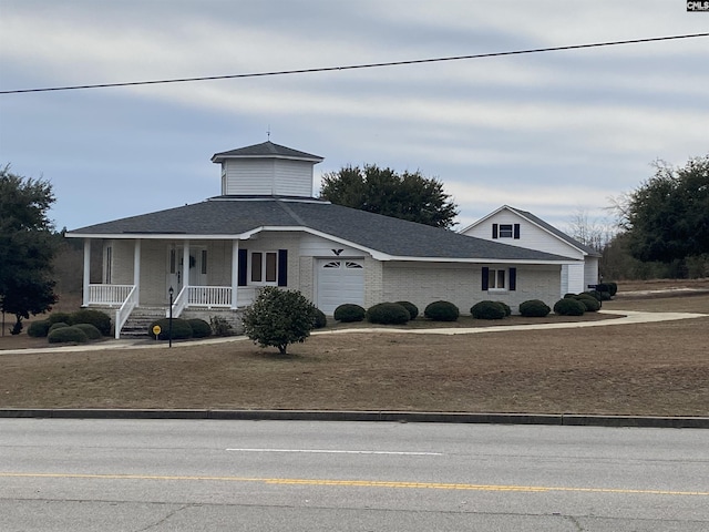 view of front of home featuring a porch and a garage