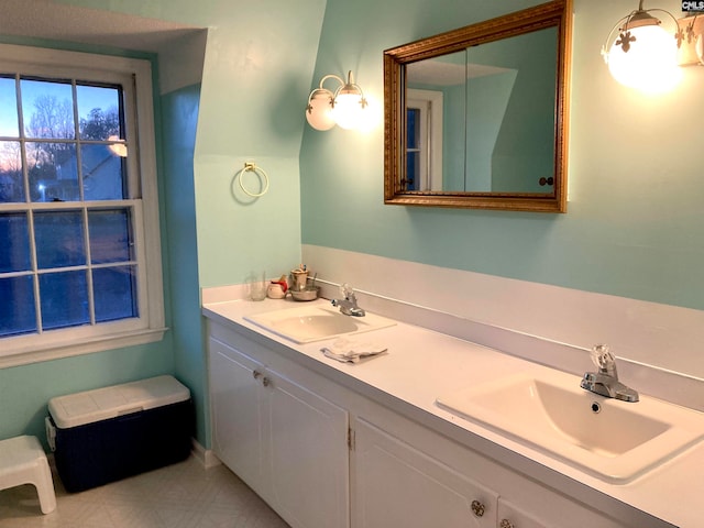 bathroom with double vanity, tile patterned floors, and toilet