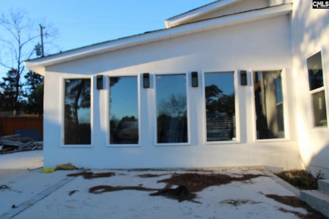 view of side of property featuring a patio area