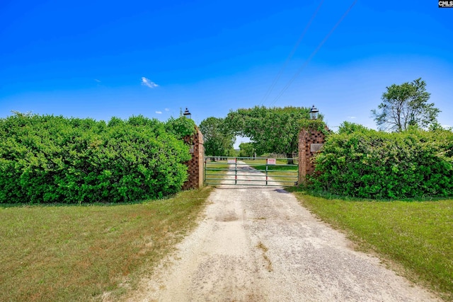 view of gate with a rural view