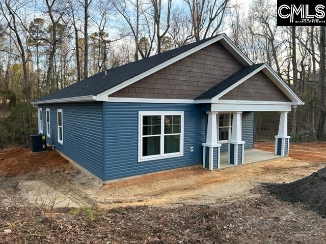 rear view of property with central AC