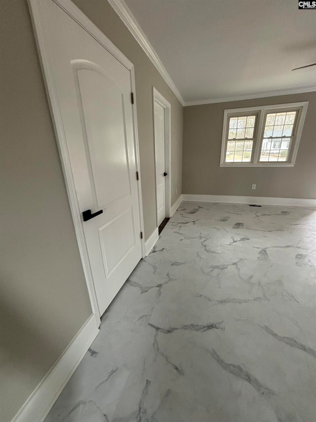 hallway featuring ornamental molding and light tile floors