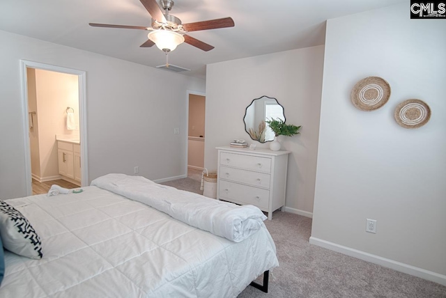 carpeted bedroom featuring ensuite bath and ceiling fan