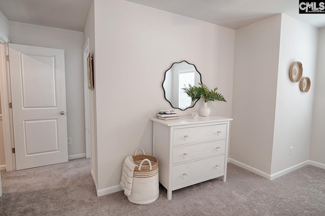 hallway featuring light colored carpet