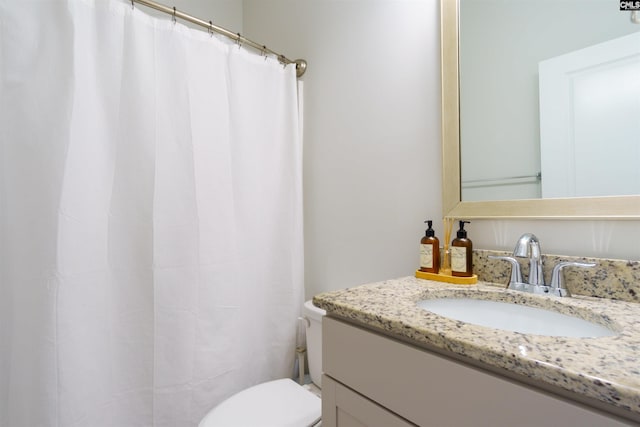 bathroom with toilet and vanity