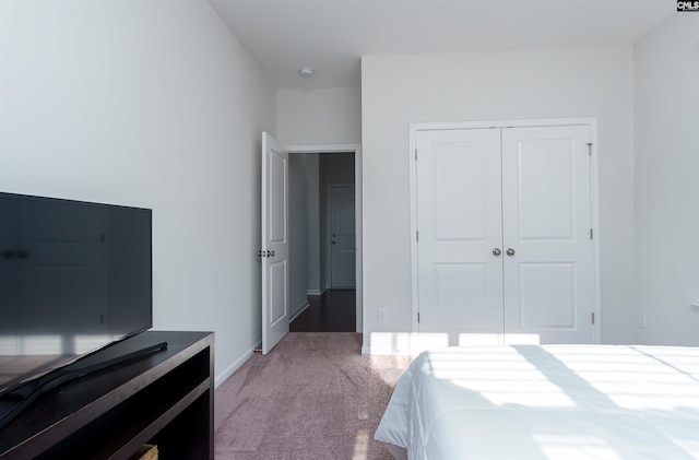 carpeted bedroom with a closet