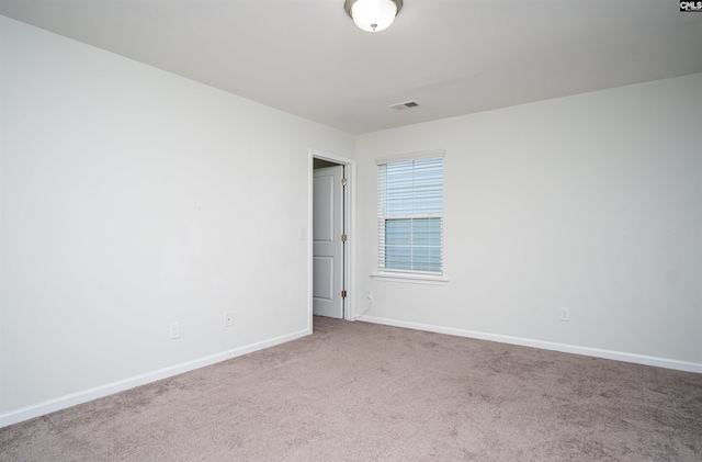 unfurnished room featuring light colored carpet