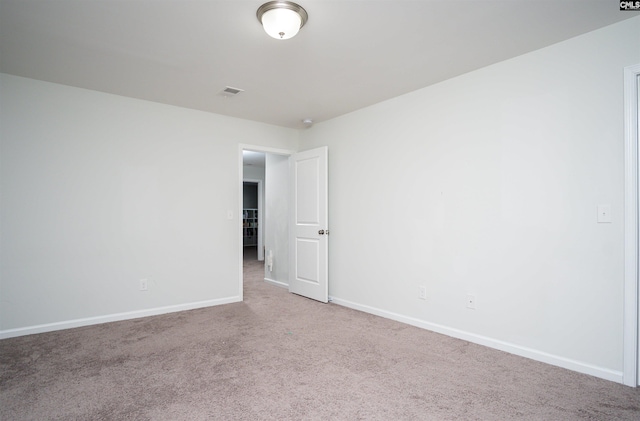 unfurnished room featuring light carpet