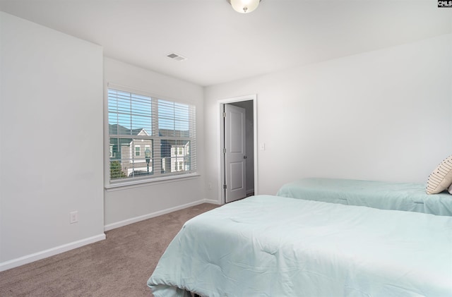 bedroom featuring light colored carpet