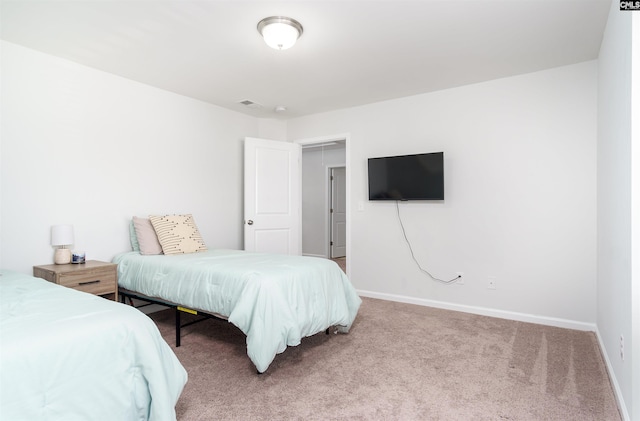 bedroom featuring light colored carpet