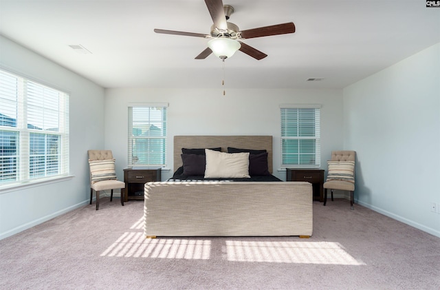 bedroom with ceiling fan and light colored carpet