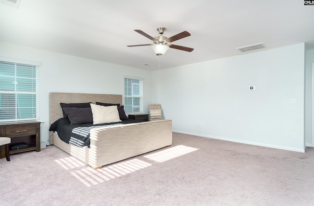 bedroom with ceiling fan and light colored carpet