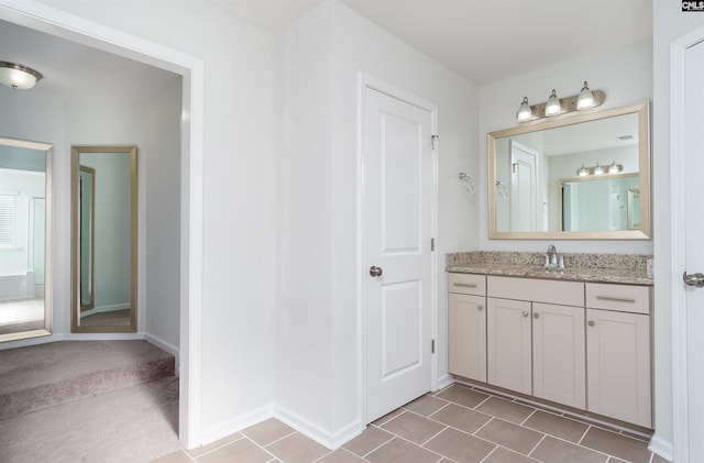 bathroom with tile flooring and vanity