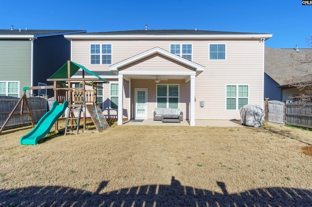 back of house with a lawn, a playground, a patio, and ceiling fan