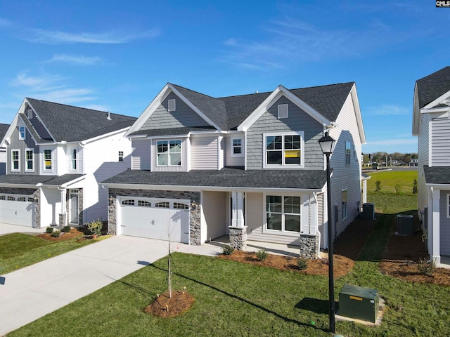 view of front of house with a garage, a front lawn, and central air condition unit