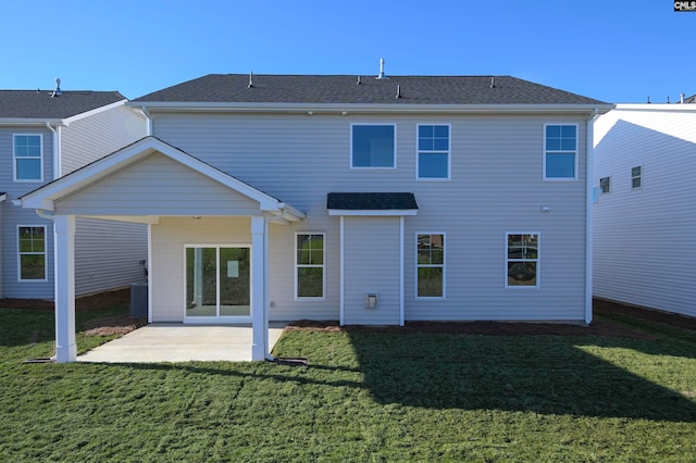 back of house featuring a patio area and a lawn