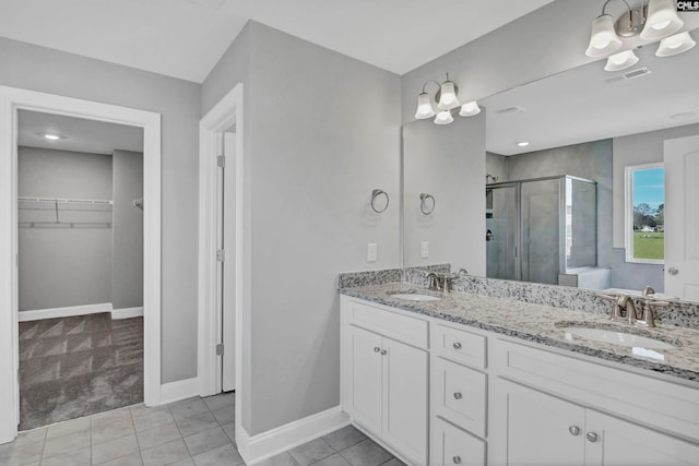 bathroom with tile patterned floors, vanity, and walk in shower