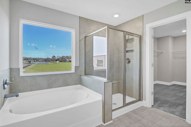 bathroom featuring tile patterned flooring and plus walk in shower