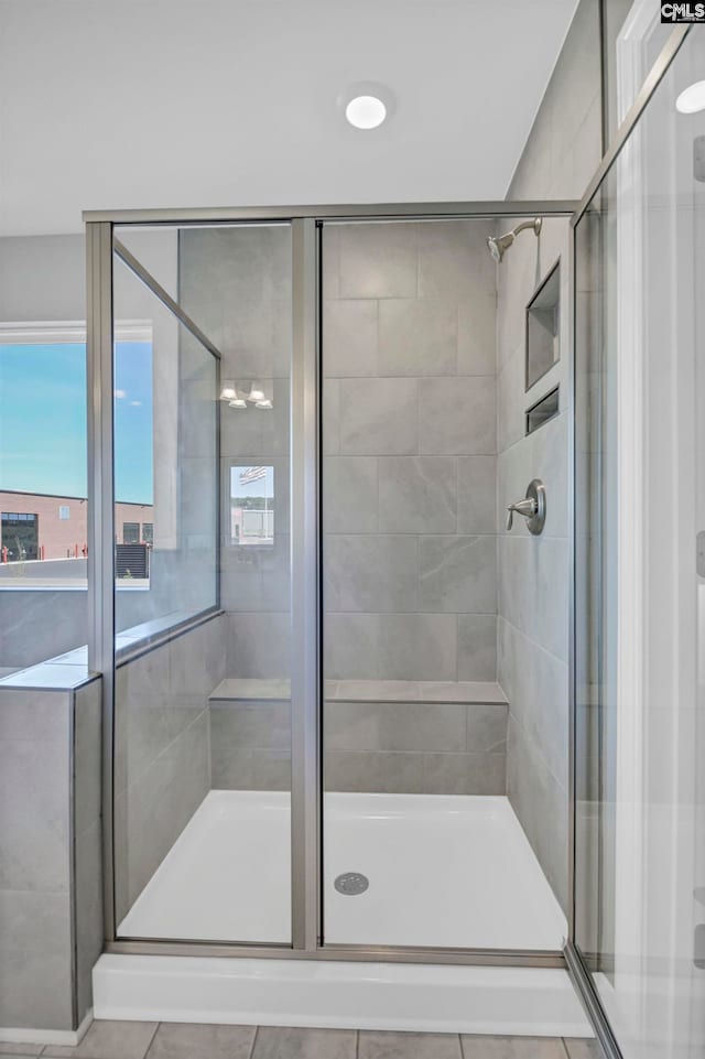 bathroom with tile patterned flooring and an enclosed shower