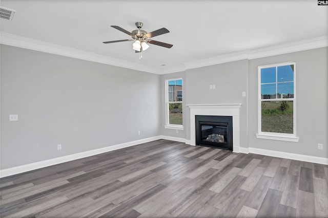 unfurnished living room featuring ceiling fan, wood-type flooring, and ornamental molding