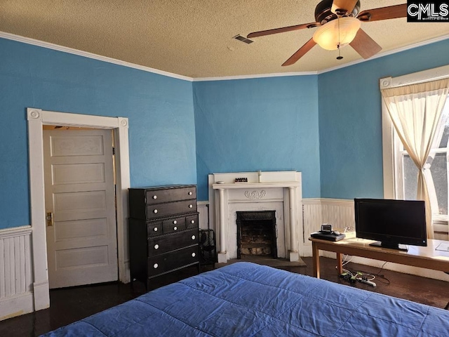 bedroom featuring a textured ceiling, dark hardwood / wood-style floors, ceiling fan, and ornamental molding