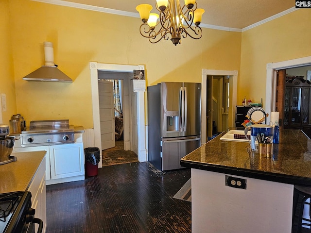 kitchen with stainless steel fridge, dark hardwood / wood-style flooring, wall chimney exhaust hood, an inviting chandelier, and white cabinetry