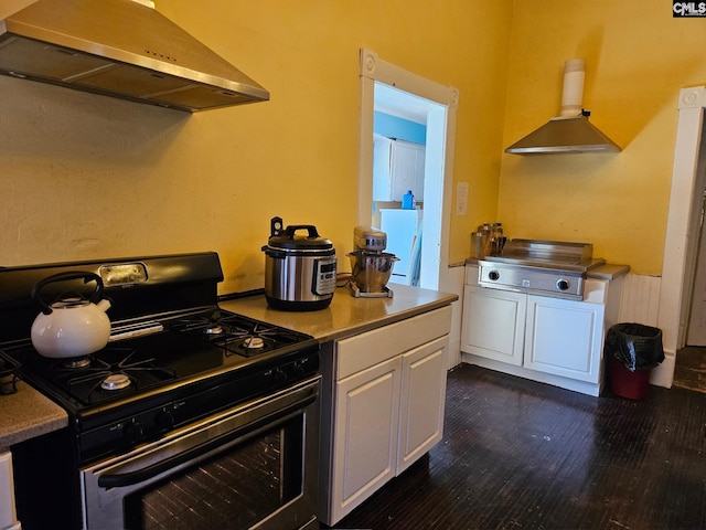 kitchen featuring white cabinets, double oven range, dark hardwood / wood-style floors, and wall chimney exhaust hood