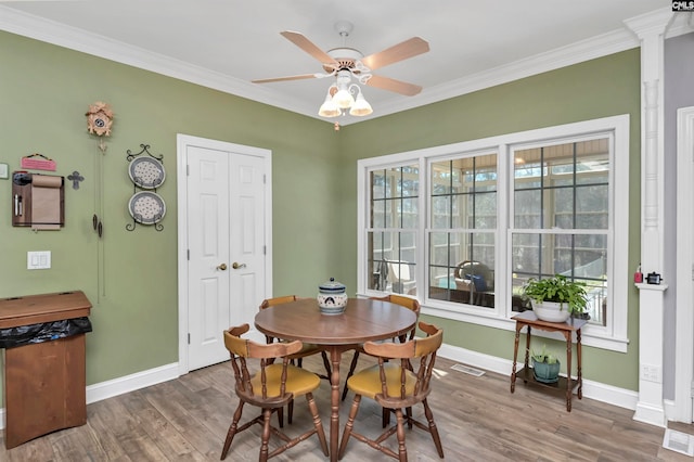 230 Wildlife Rd, Lexington, SC 29072 - dining area featuring dark wood-type flooring, ceiling fan, and crown molding