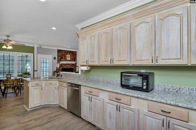 230 Wildlife Rd, Lexington, SC 29072 - kitchen featuring stainless steel dishwasher, a fireplace, ceiling fan, light wood-type flooring, and light stone counters
