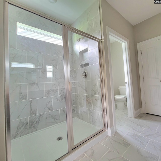 bathroom with an enclosed shower and toilet