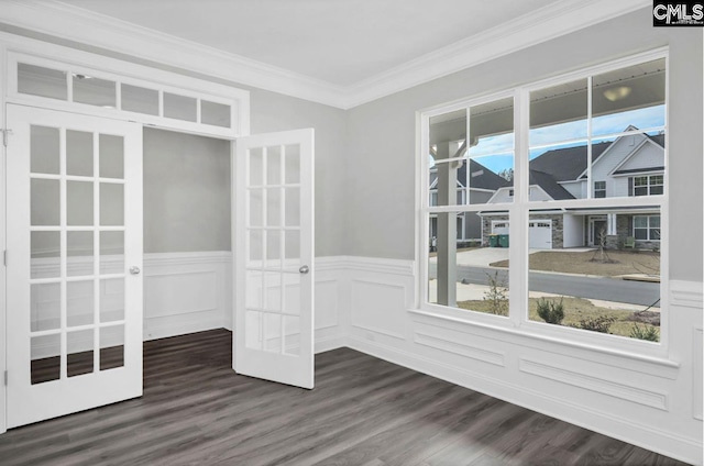 spare room featuring crown molding, dark hardwood / wood-style flooring, and french doors