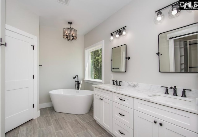 bathroom featuring tile floors, double sink, and oversized vanity