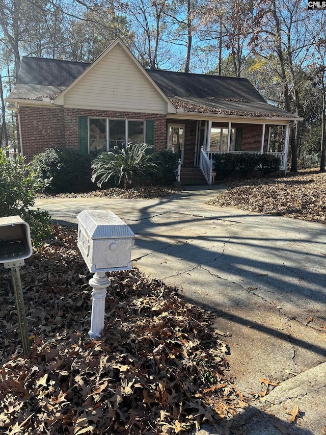 single story home featuring covered porch