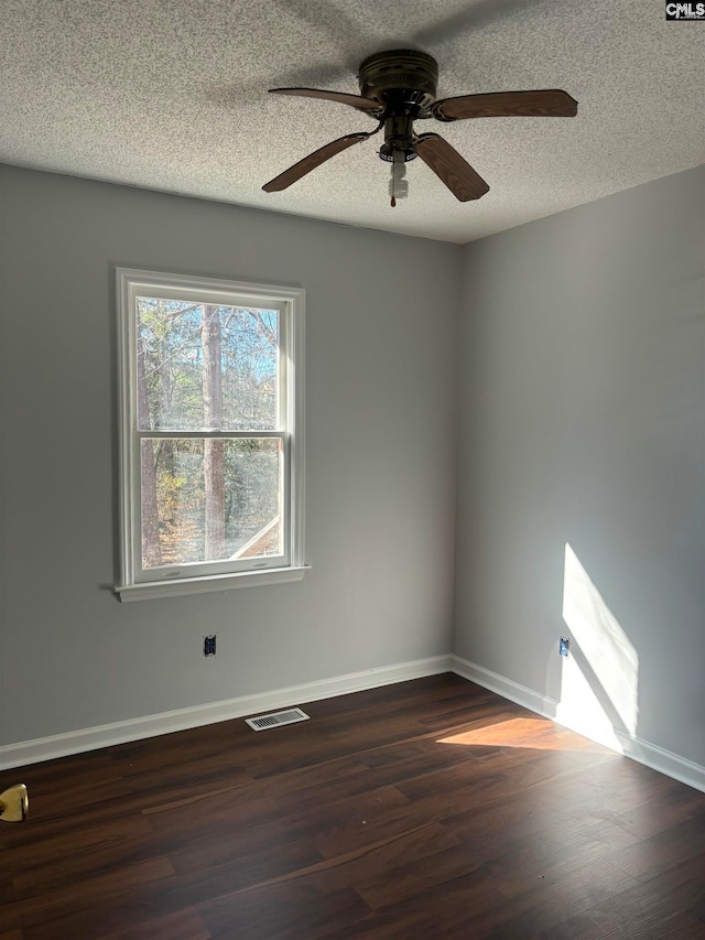 spare room featuring a textured ceiling, ceiling fan, and hardwood / wood-style floors