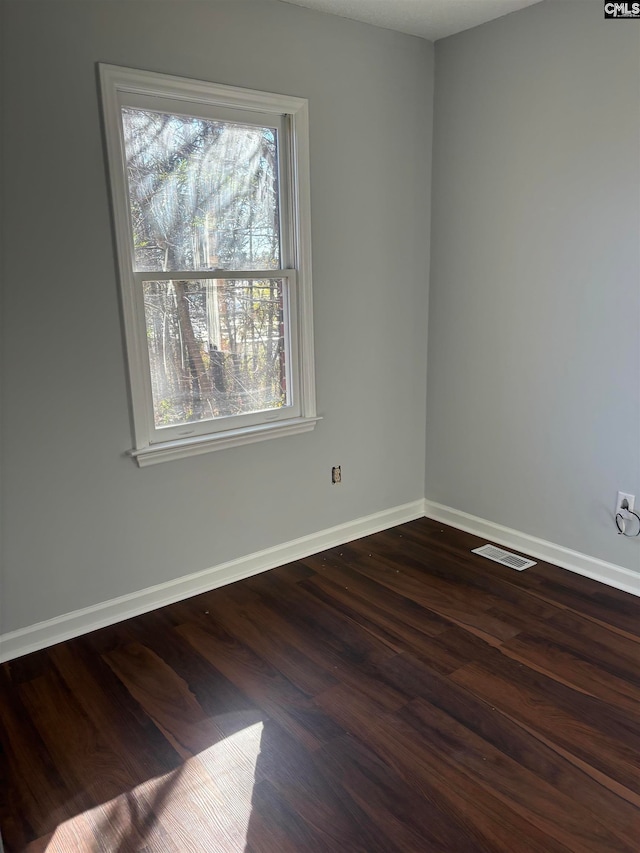 spare room with dark hardwood / wood-style floors