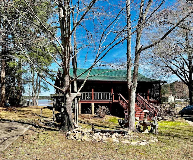 exterior space featuring a water view and a yard