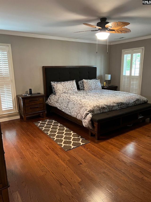 bedroom featuring ceiling fan, crown molding, and dark hardwood / wood-style floors