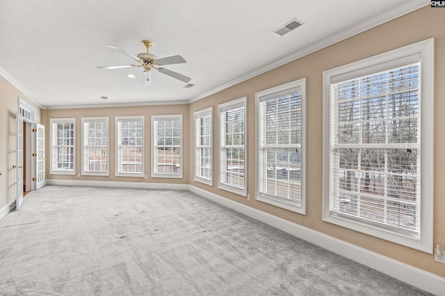 unfurnished sunroom featuring ceiling fan and french doors