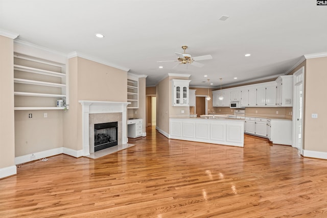 unfurnished living room with ornamental molding, ceiling fan, and light hardwood / wood-style flooring