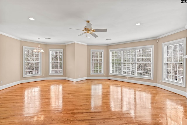 empty room with crown molding, ceiling fan with notable chandelier, and light hardwood / wood-style floors